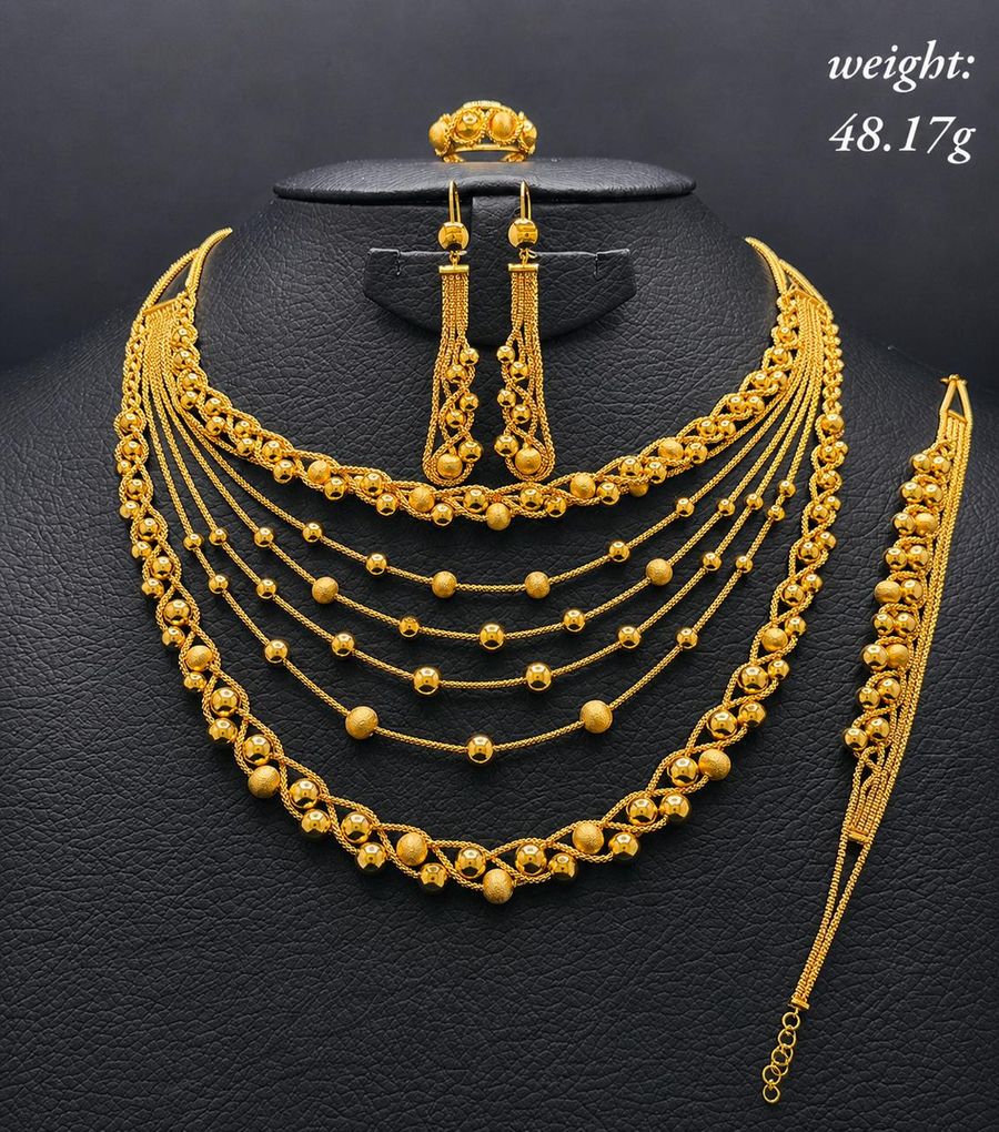 Multi-strand gold beaded necklace set with earrings, ring and bracelet
