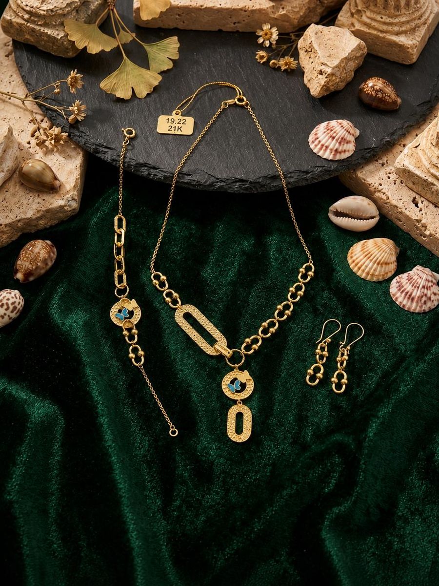 Gold chain necklace, bracelet and earring set with butterfly detail